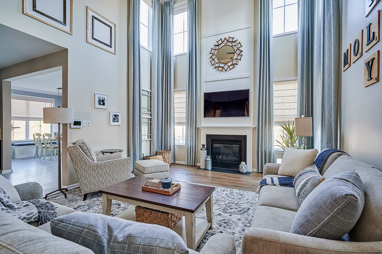 The large floorplan of this family room allows for the TV being placed over the mantel as the viewers are far from the screen.