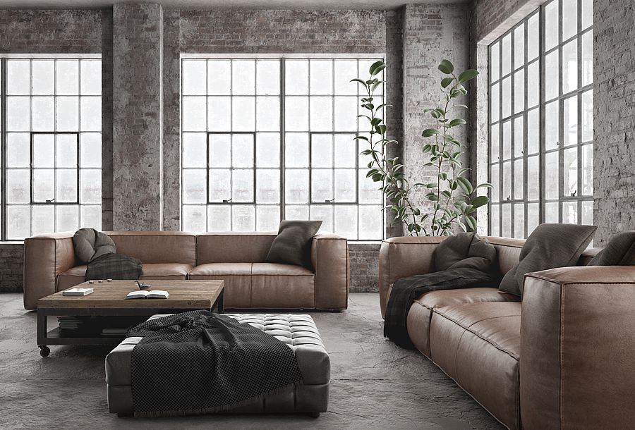 This industrial living room makeover in a loft uses warm colors to work with the cold concrete and ducting that can be part of loft living.